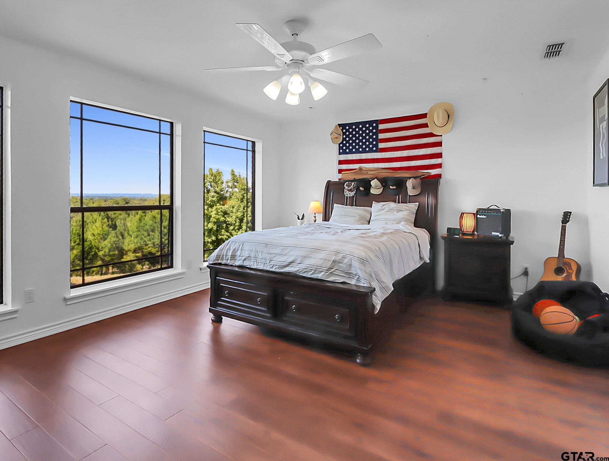 307 Roesch Road Hallsville, TX 75650 - Photo 29 of 40 a bedroom with a bed and a chandelier