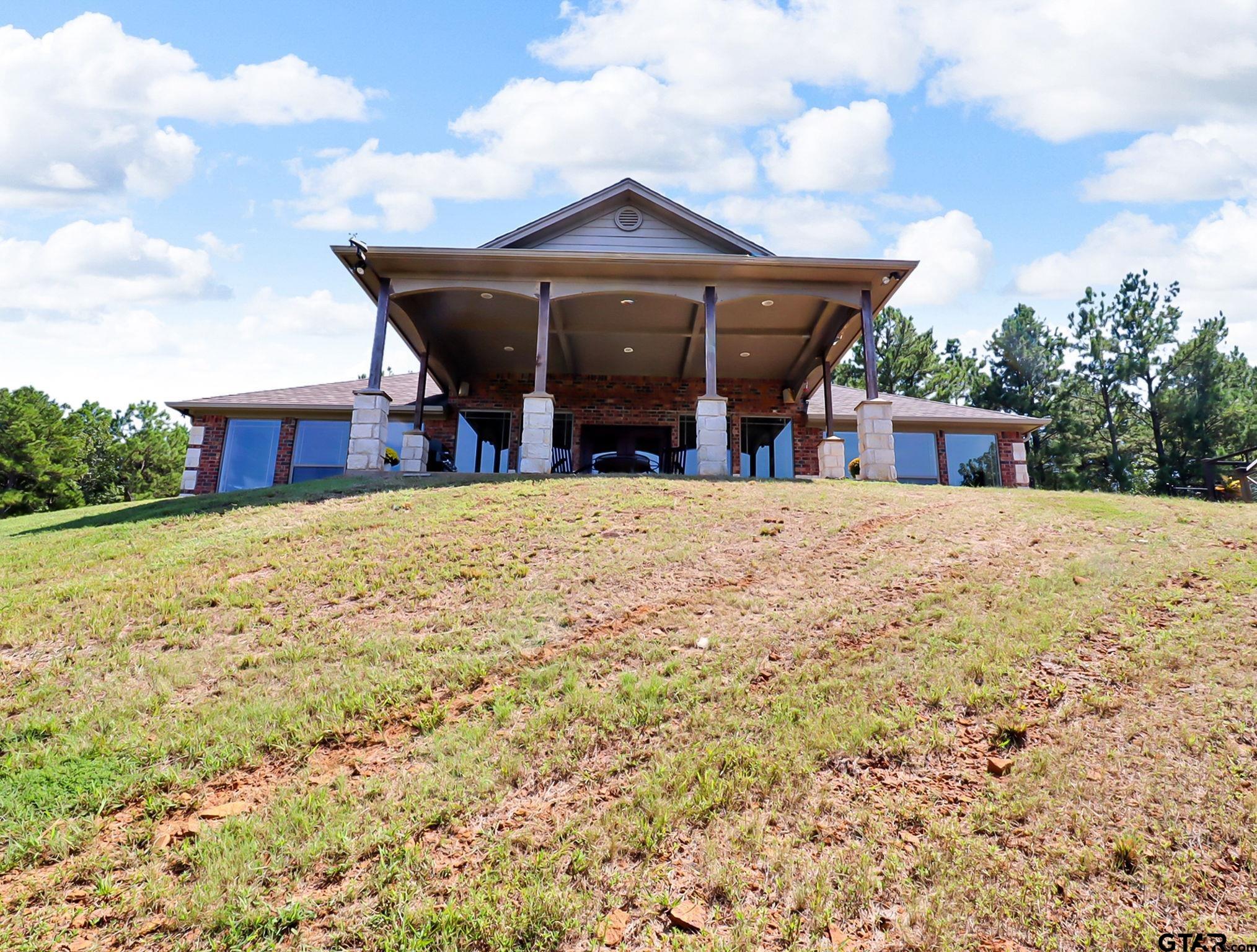 307 Roesch Road Hallsville, TX 75650 - Photo 33 of 40 a view of a house with a yard and sitting area