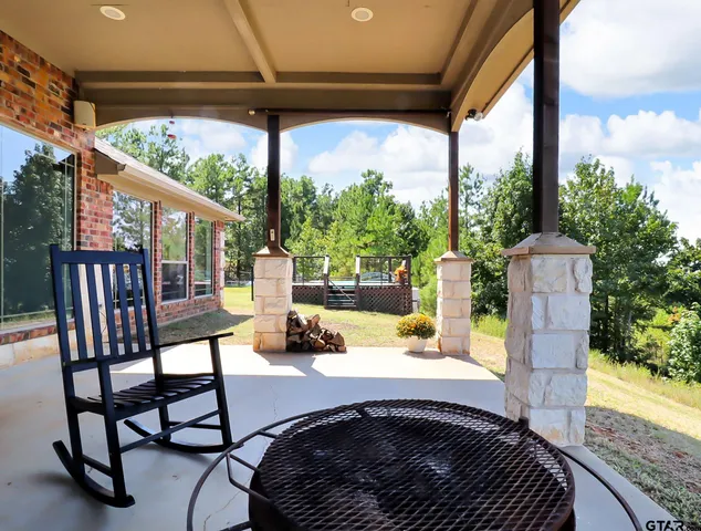 a view of a patio with a table chairs and a backyard