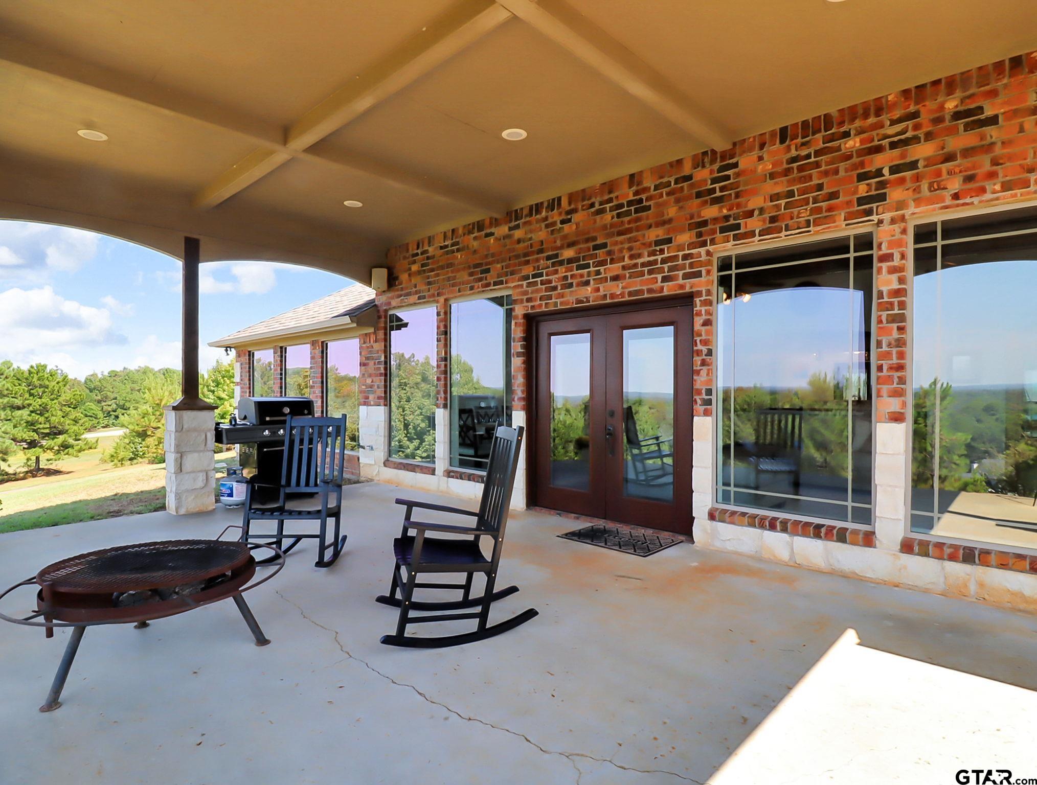 307 Roesch Road Hallsville, TX 75650 - Photo 35 of 40 a living room with patio furniture and a floor to ceiling window