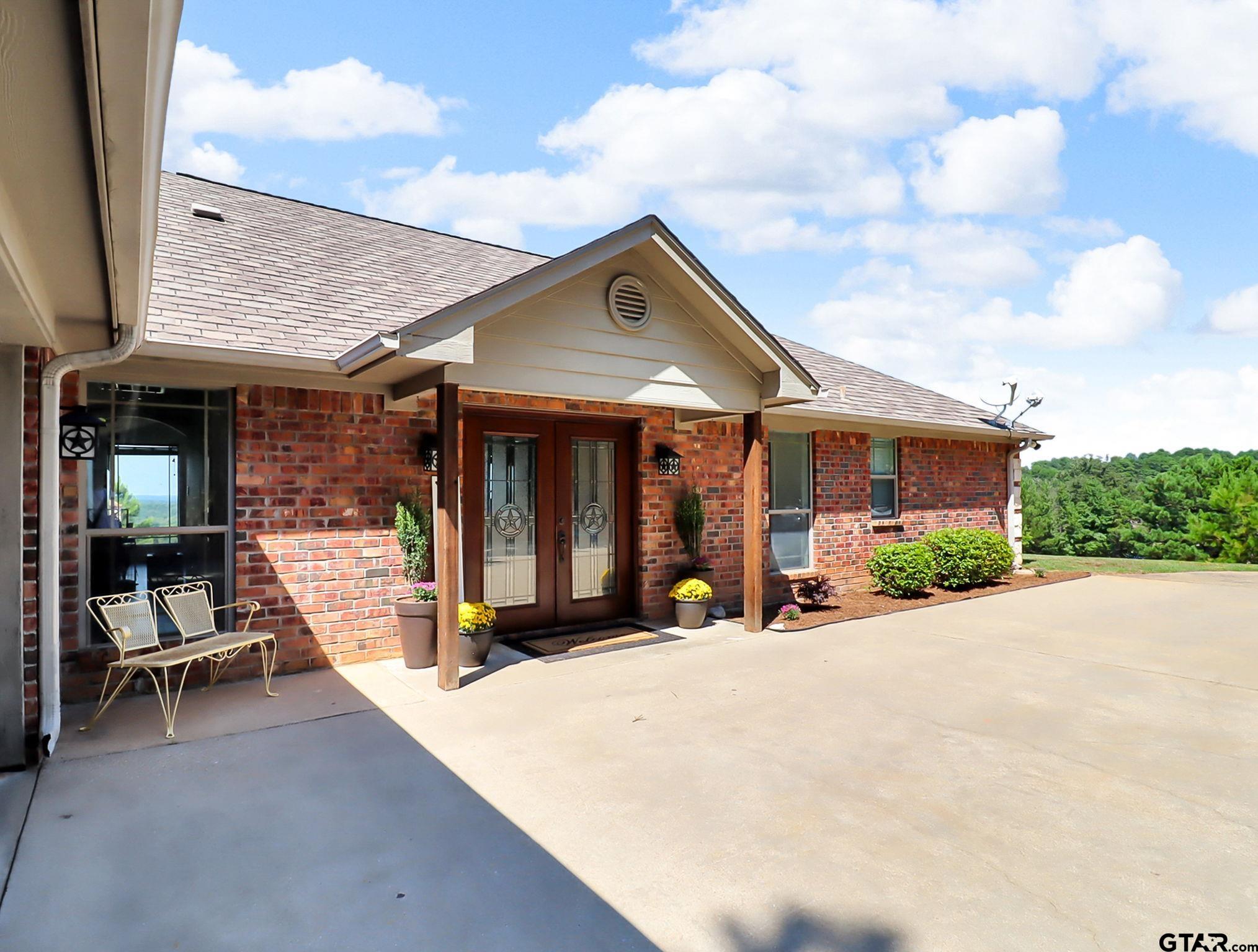 307 Roesch Road Hallsville, TX 75650 - Photo 36 of 40 a view of a house with sitting area and roof