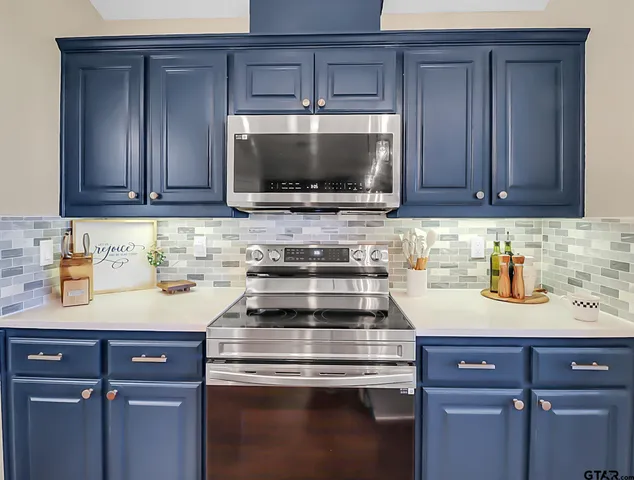 a kitchen with a sink stove and microwave