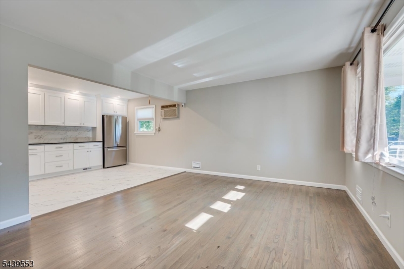 15 Woodmere Street Raritan, NJ 08869 - Photo 4 of 16 an empty room with wooden floor and a window