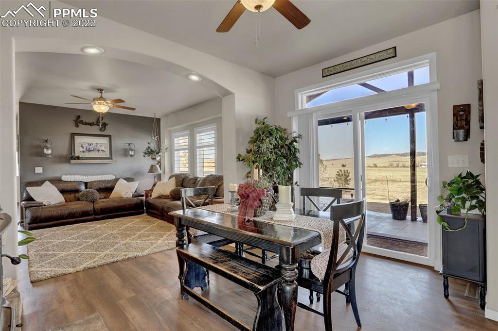 24335 Sweet Road Calhan, CO 80808 - Photo 11 of 39 a living room with furniture potted plant and a chandelier