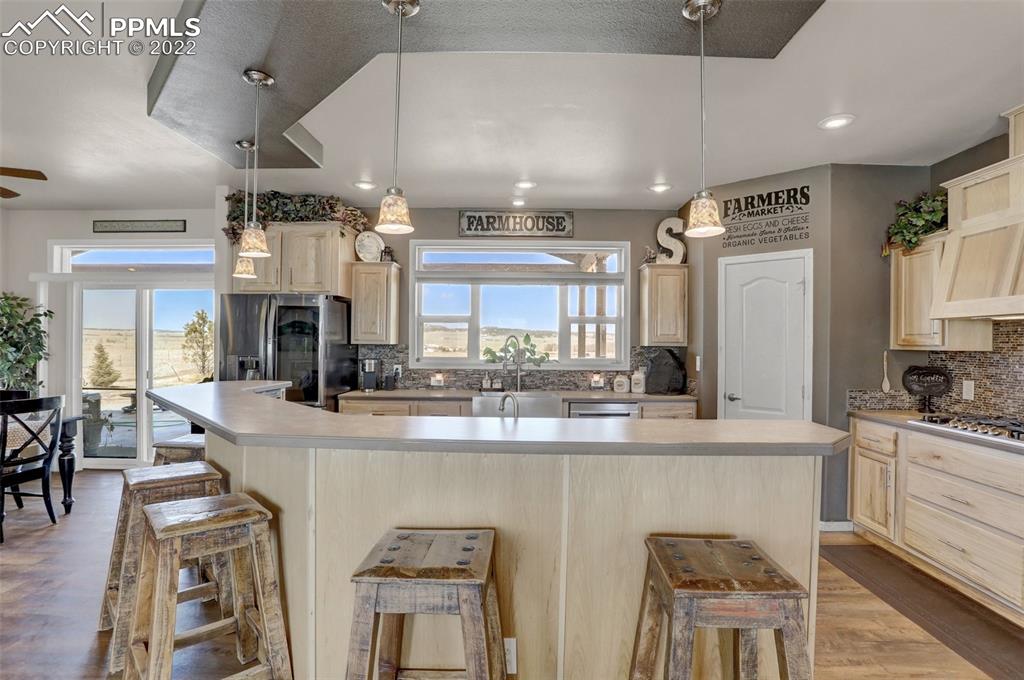 24335 Sweet Road Calhan, CO 80808 - Photo 13 of 39 a large kitchen with a table and chairs