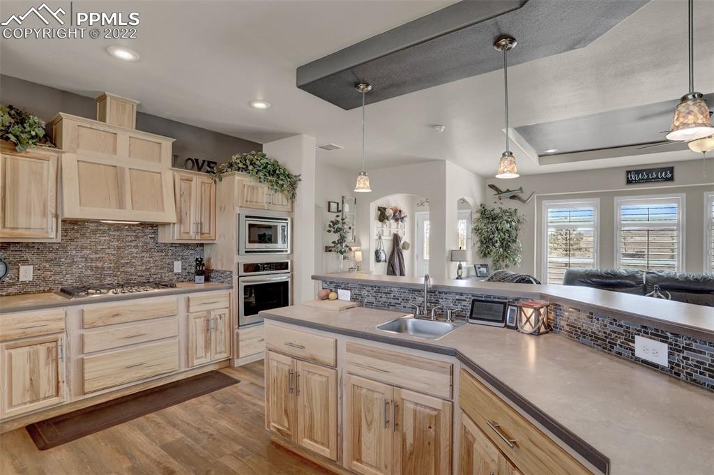 24335 Sweet Road Calhan, CO 80808 - Photo 16 of 39 a large kitchen with stainless steel appliances a large counter top a stove a sink and a refrigerator