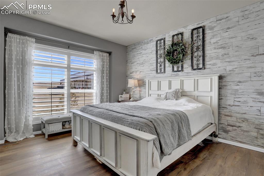 24335 Sweet Road Calhan, CO 80808 - Photo 20 of 39 a bedroom with a bed a dresser and next to a window