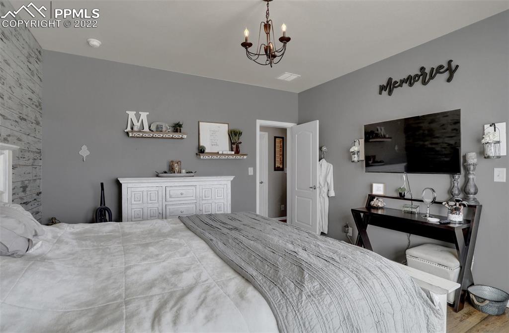 24335 Sweet Road Calhan, CO 80808 - Photo 21 of 39 a bedroom with a bed and a flat screen tv