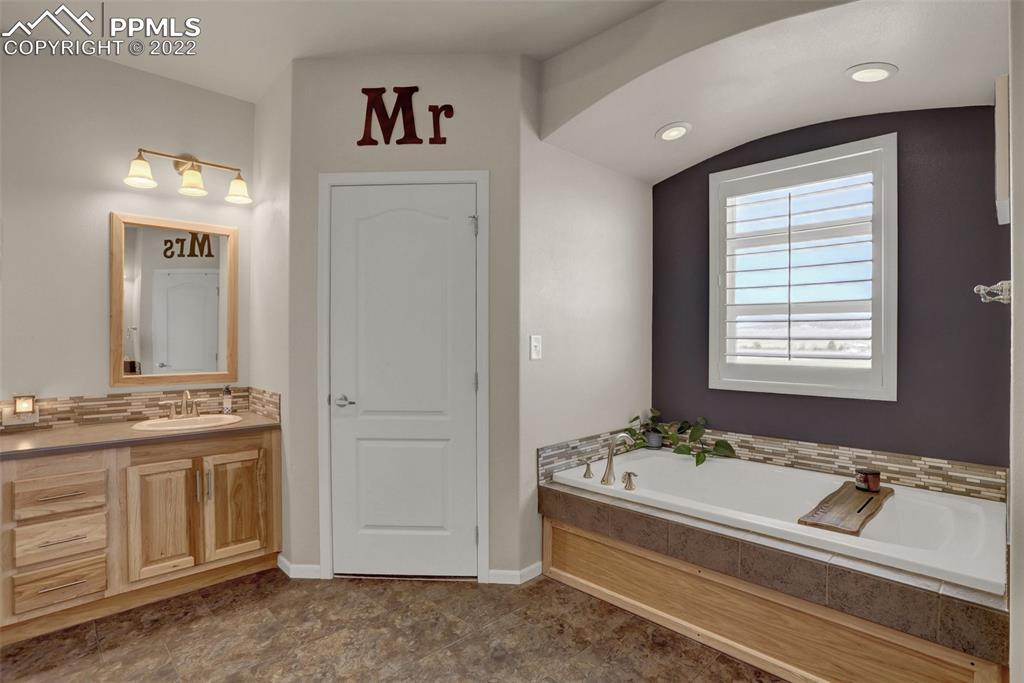 24335 Sweet Road Calhan, CO 80808 - Photo 25 of 39 a bathroom with a tub sink and mirror