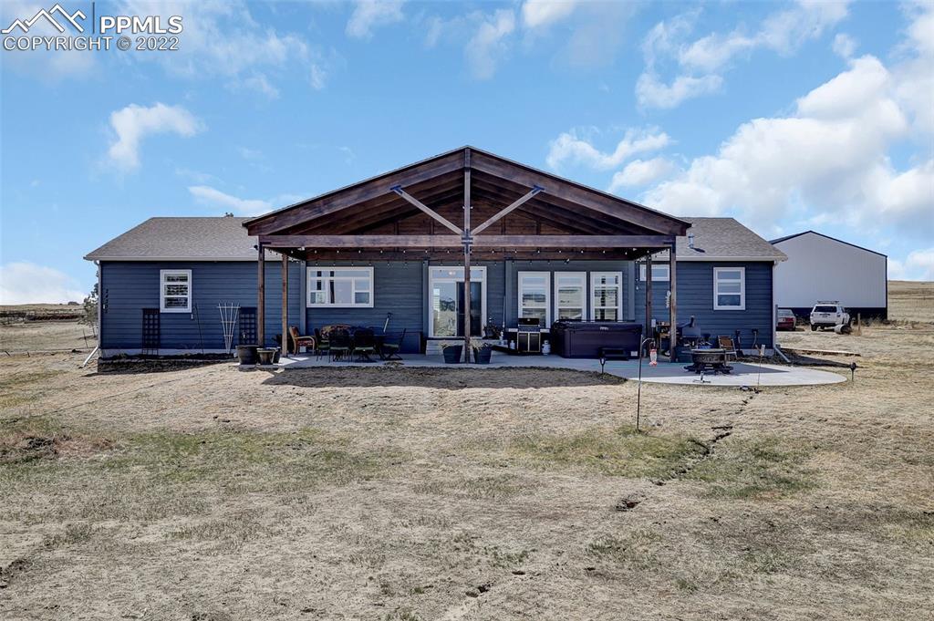 24335 Sweet Road Calhan, CO 80808 - Photo 33 of 39 a front view of a house with yard and seating space
