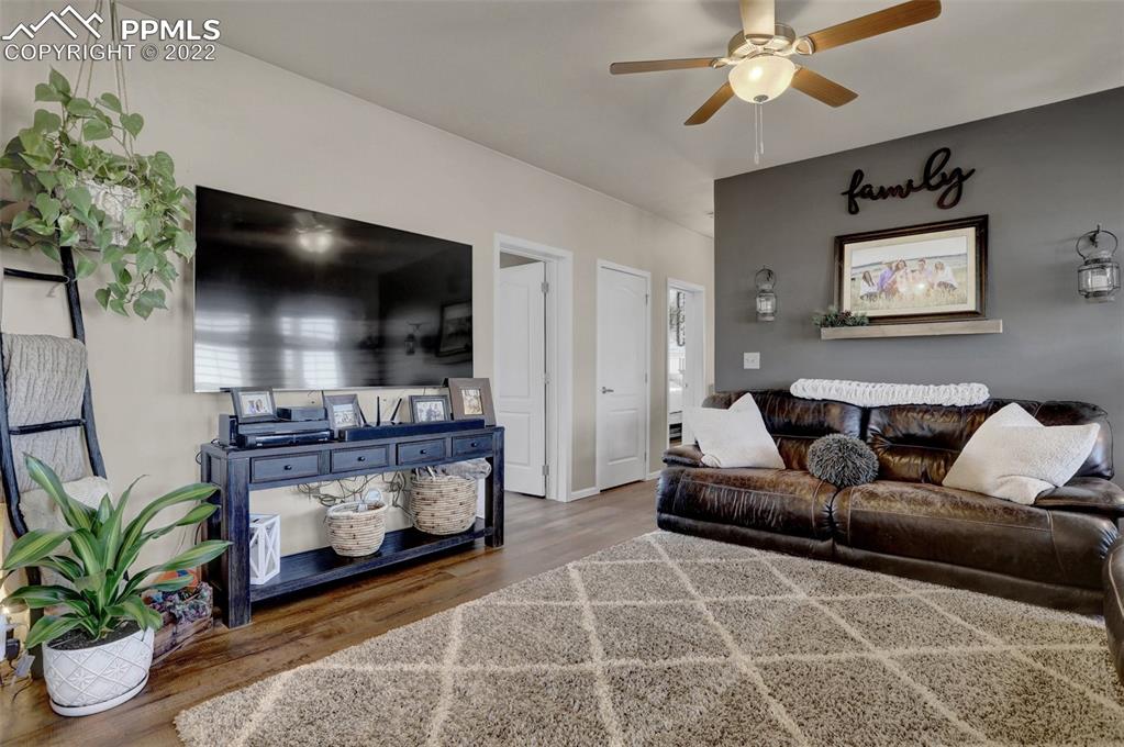 24335 Sweet Road Calhan, CO 80808 - Photo 8 of 39 a living room with furniture and a flat screen tv