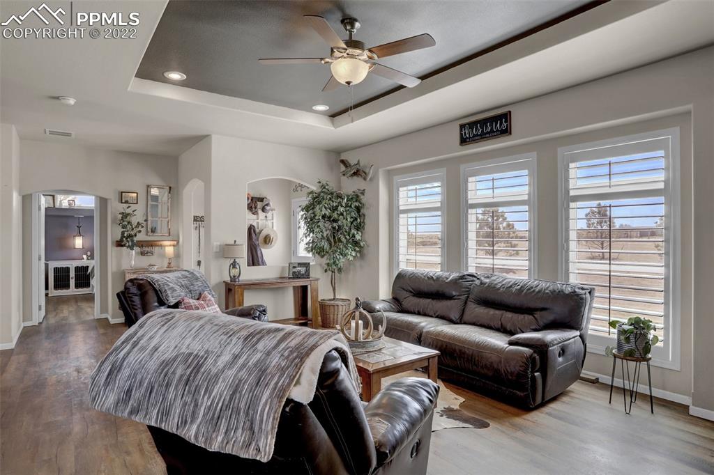 24335 Sweet Road Calhan, CO 80808 - Photo 10 of 39 a spacious bedroom with a bed a couch and a large window