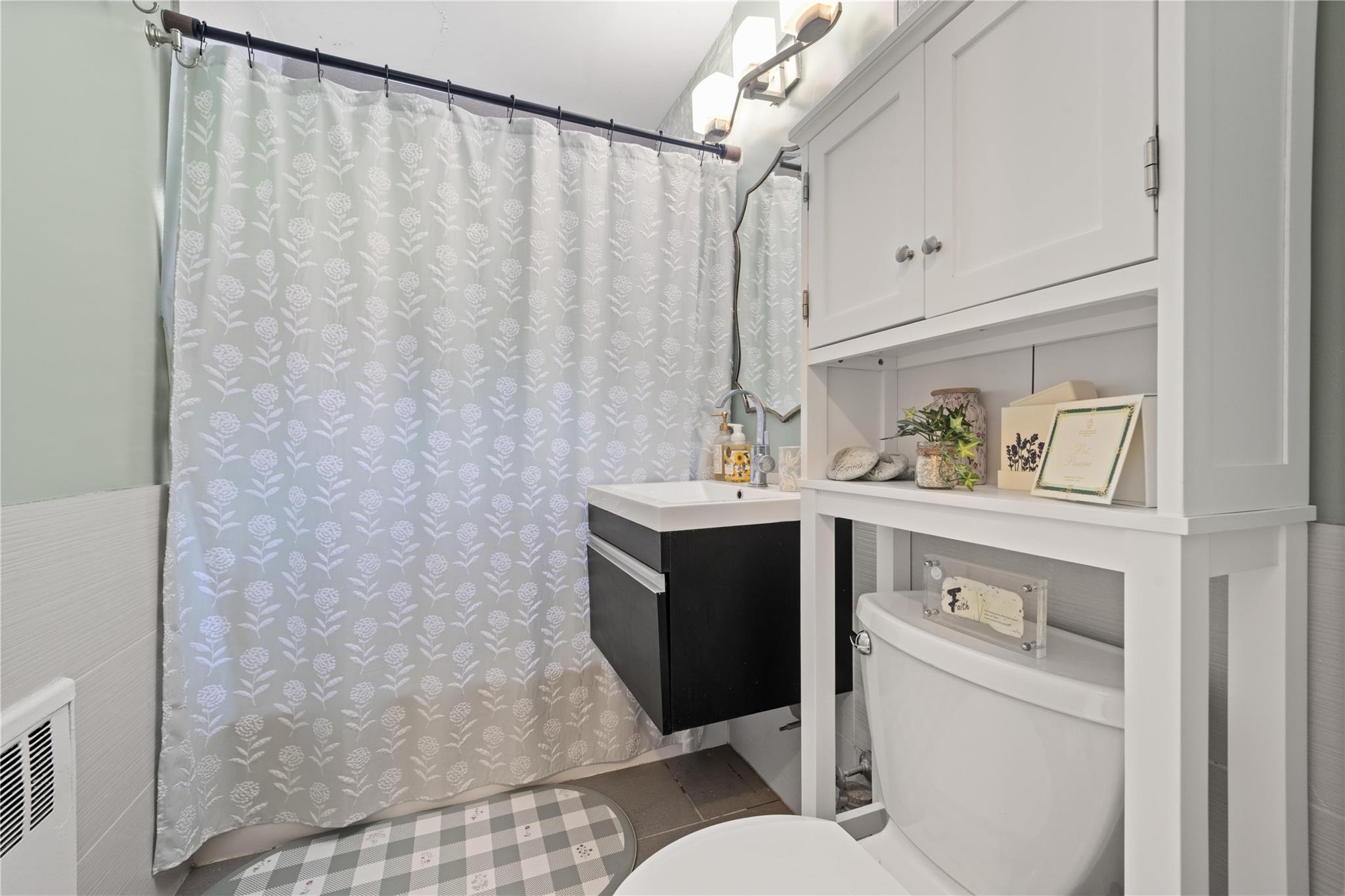 69-09 215th Street, Unit LOWER 1 Queens, NY 11364 - Photo 13 of 20 a bathroom with a sink vanity mirror and toilet