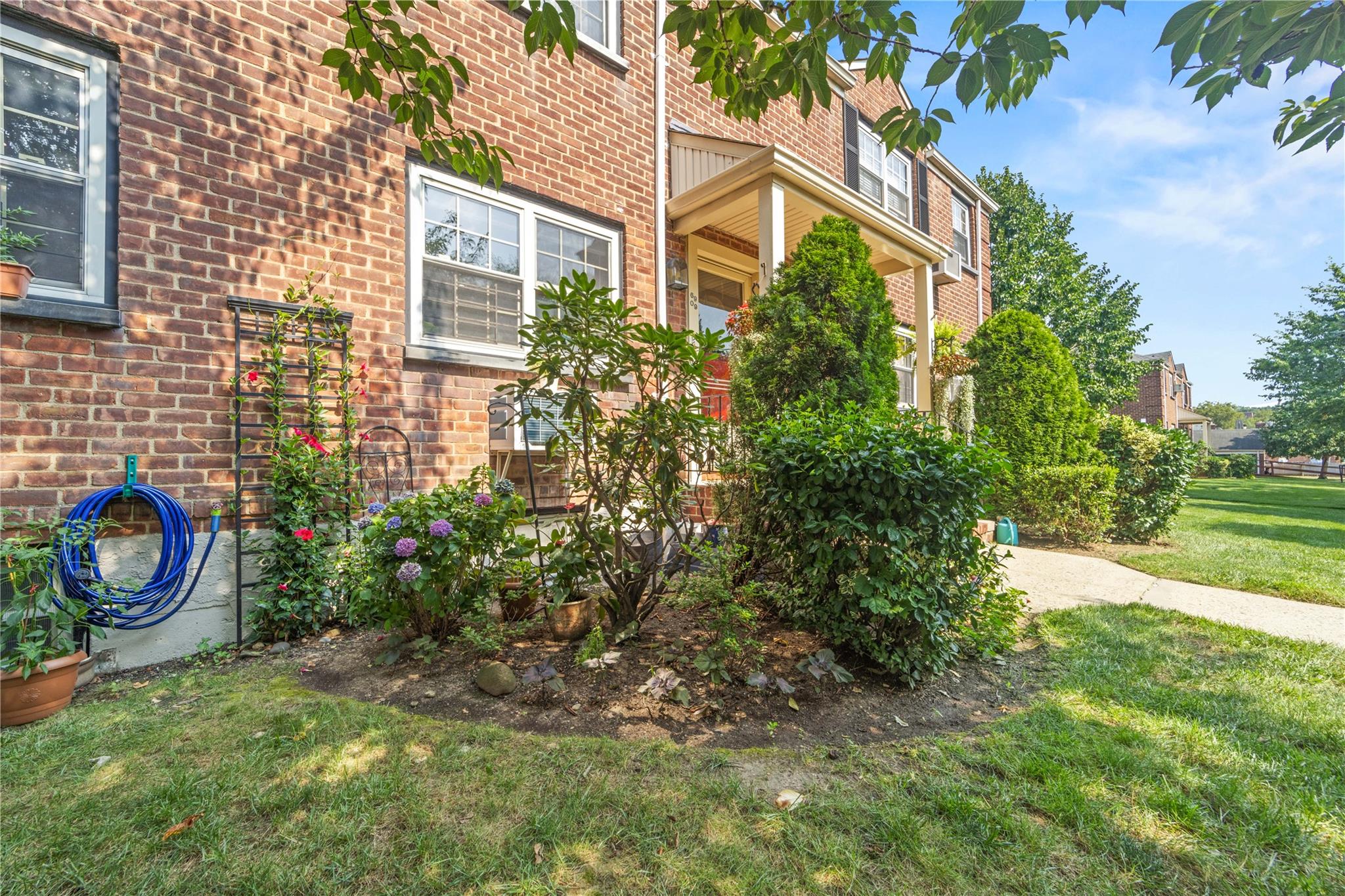 69-09 215th Street, Unit LOWER 1 Queens, NY 11364 - Photo 15 of 20 a small garden in the backyard of a house