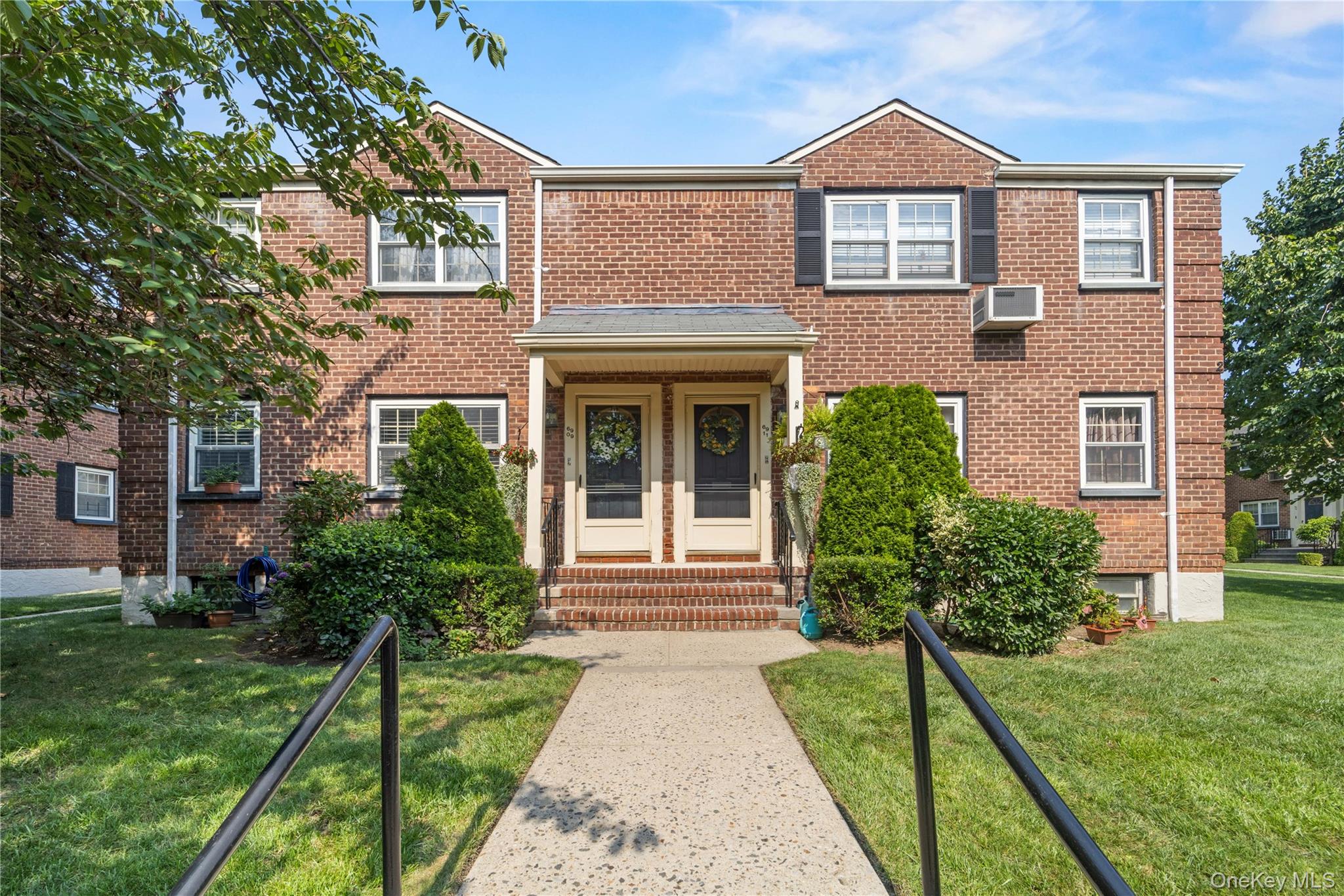 69-09 215th Street, Unit LOWER 1 Queens, NY 11364 - Photo 16 of 20 Traditional-style home featuring entry steps, a front yard, and brick siding