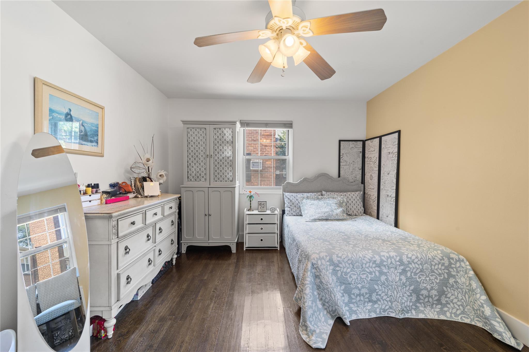 69-09 215th Street, Unit LOWER 1 Queens, NY 11364 - Photo 6 of 20 a bedroom with a bed and a chandelier