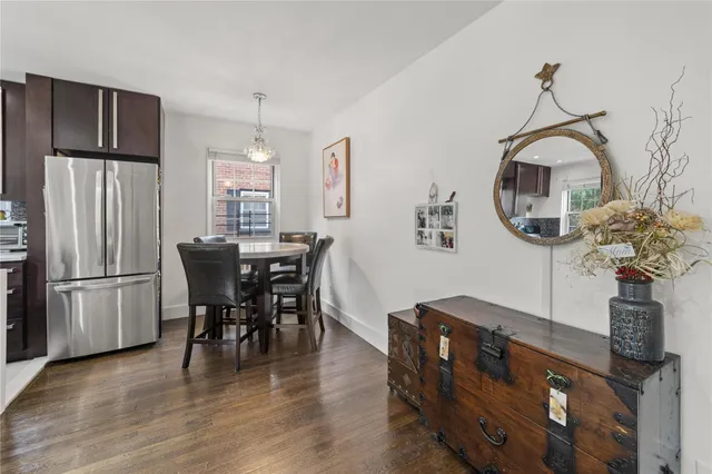 a dining room with furniture a chandelier and wooden floor
