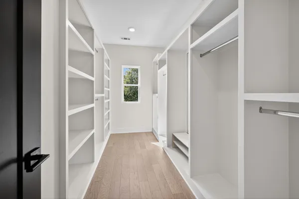 a view of entryway and hall with wooden floor