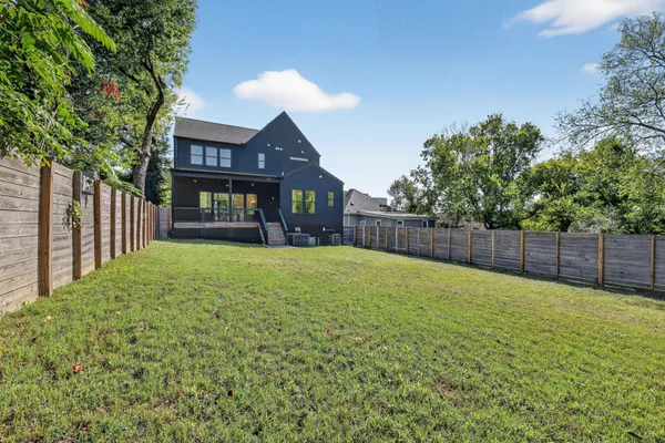 a view of a house with a yard and porch