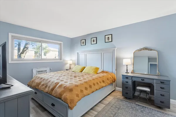 a bedroom with a bed and a dresser