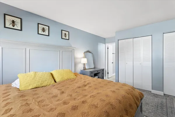 a large bed sitting in a bedroom and a table
