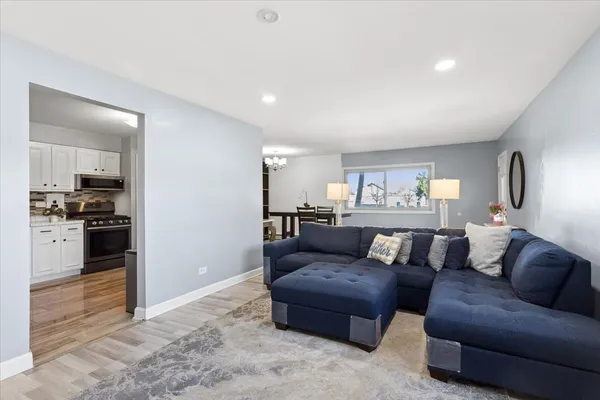 a living room with furniture and a kitchen