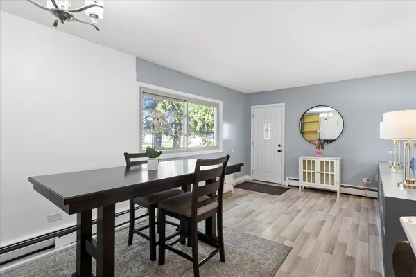 a view of a dining room with furniture and wooden floor