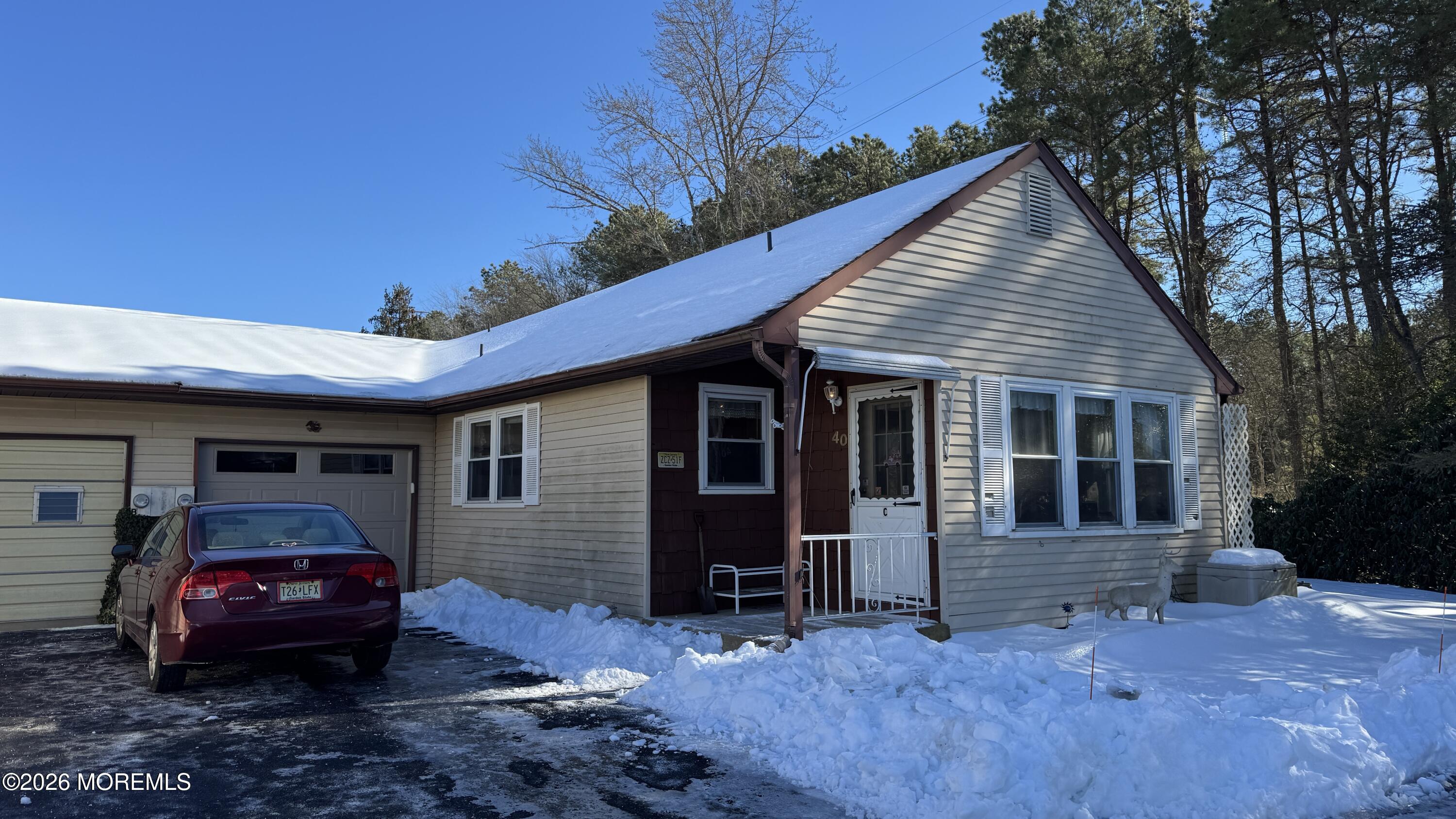 a view of a house with a cars park side of a road