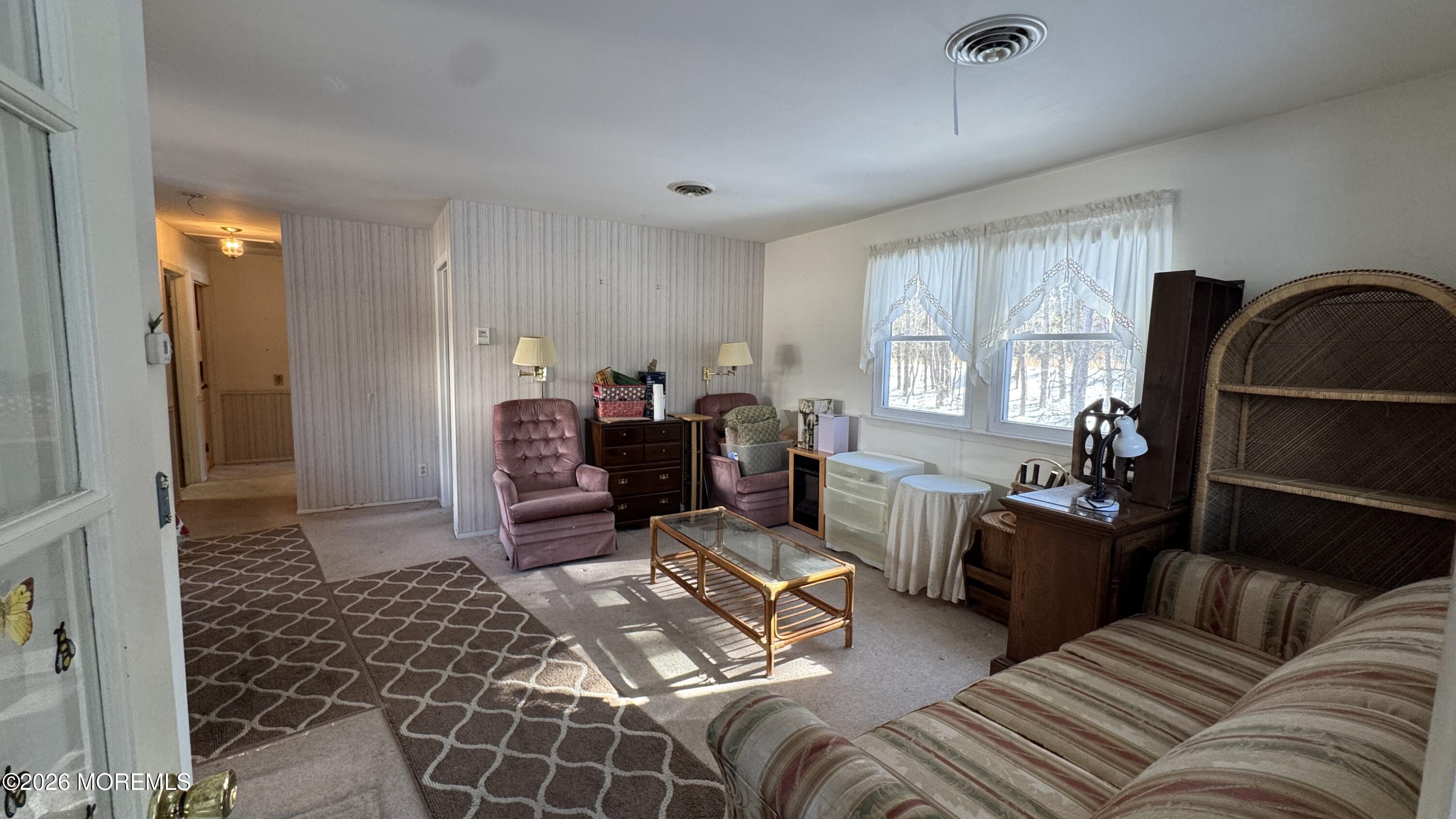 40A Stonybrook Road, Unit 62 Whiting, NJ 08759 - Photo 3 of 12 a living room with furniture a couch and a window