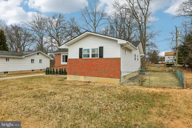 a view of a house with a yard covered with snow
