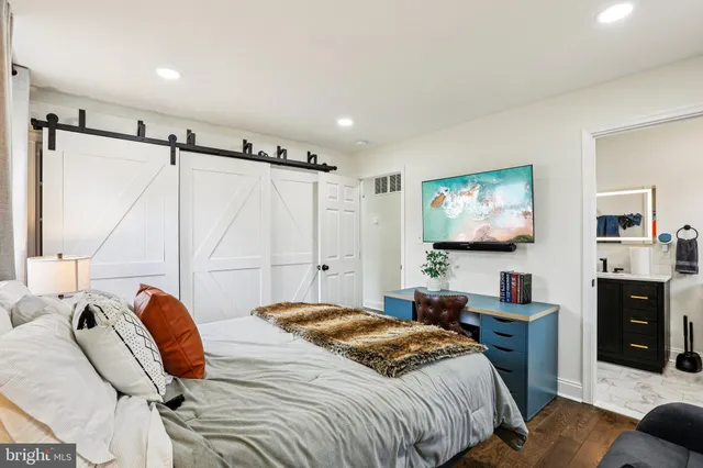 a bedroom with two bed and a wall painting