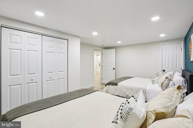 a bedroom with a bed and painting on the wall