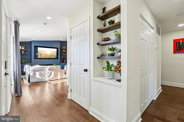 a view of a livingroom with wooden floor and a flat screen tv