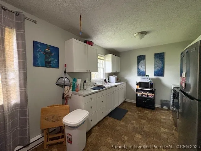 a room with furniture a flat screen tv and a bathroom