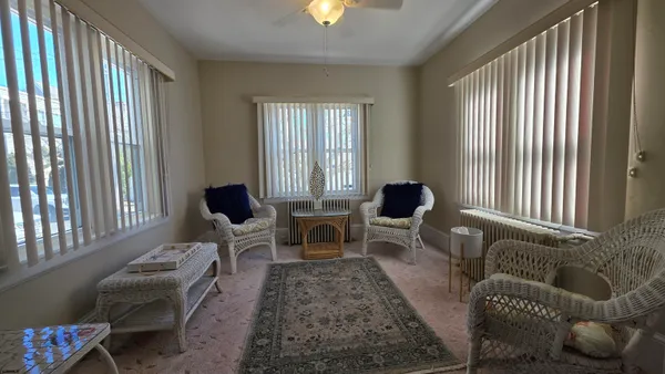 a living room with furniture and a lamp