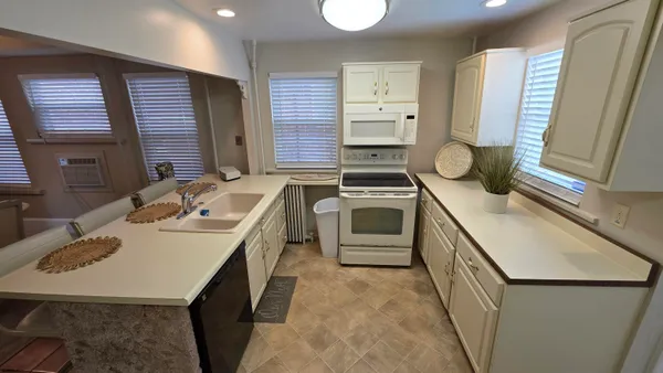 a kitchen that has a sink and a stove