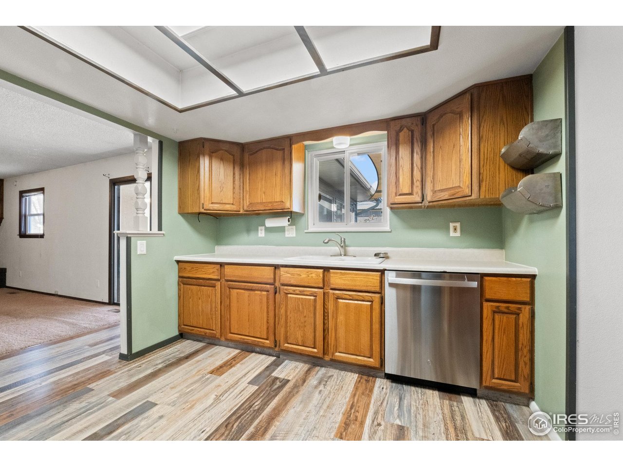 310 Apache Street Fort Morgan, CO 80701 - Photo 14 of 50 a kitchen with stainless steel appliances granite countertop wooden cabinets a sink and dishwasher