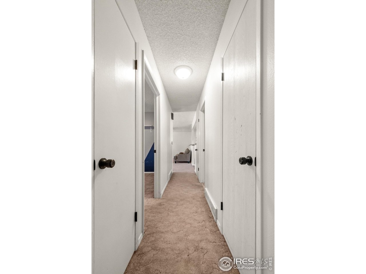 310 Apache Street Fort Morgan, CO 80701 - Photo 19 of 50 a view of a hallway with wooden floor