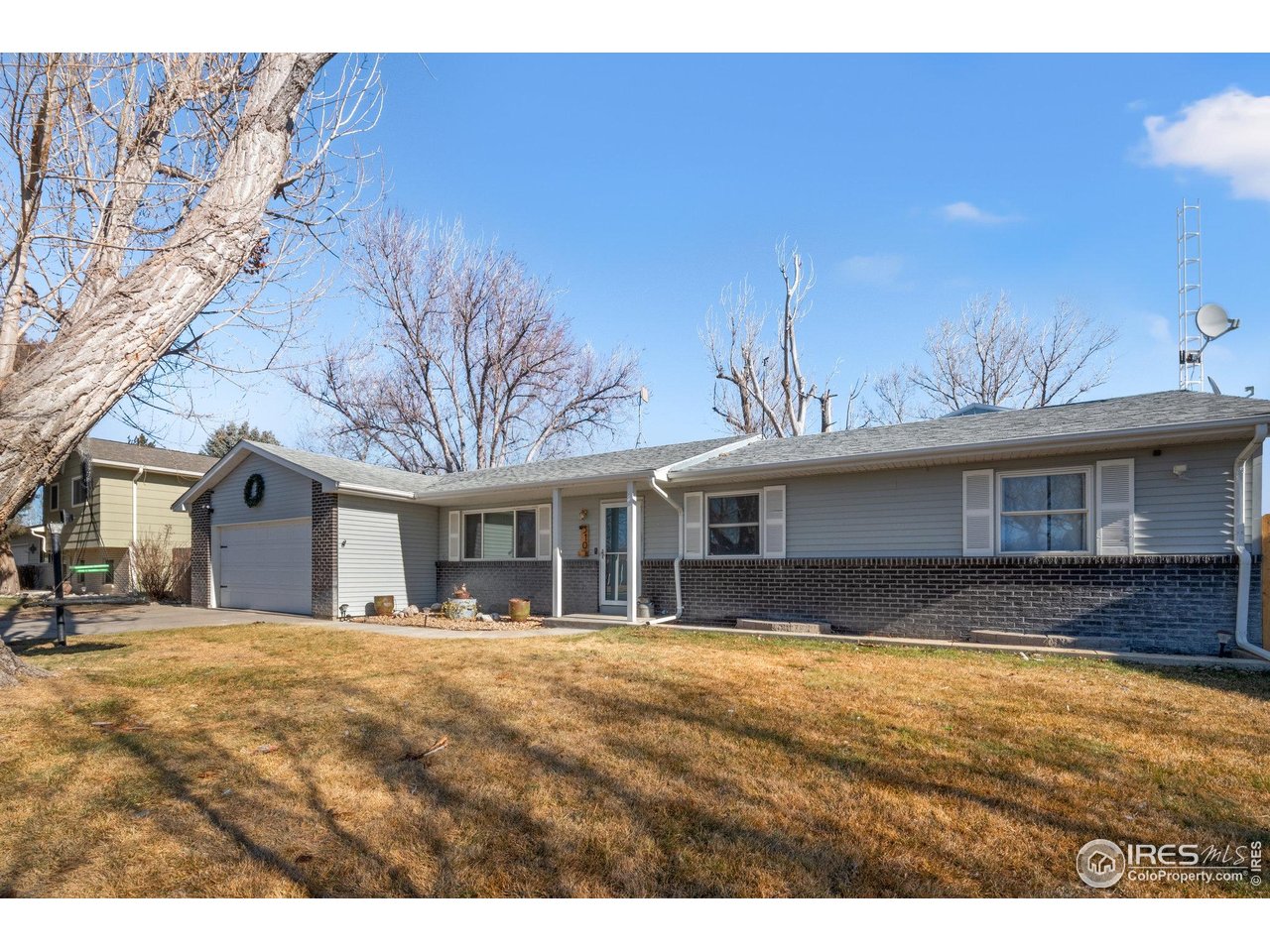 310 Apache Street Fort Morgan, CO 80701 - Photo 2 of 50 a front view of a house with a yard