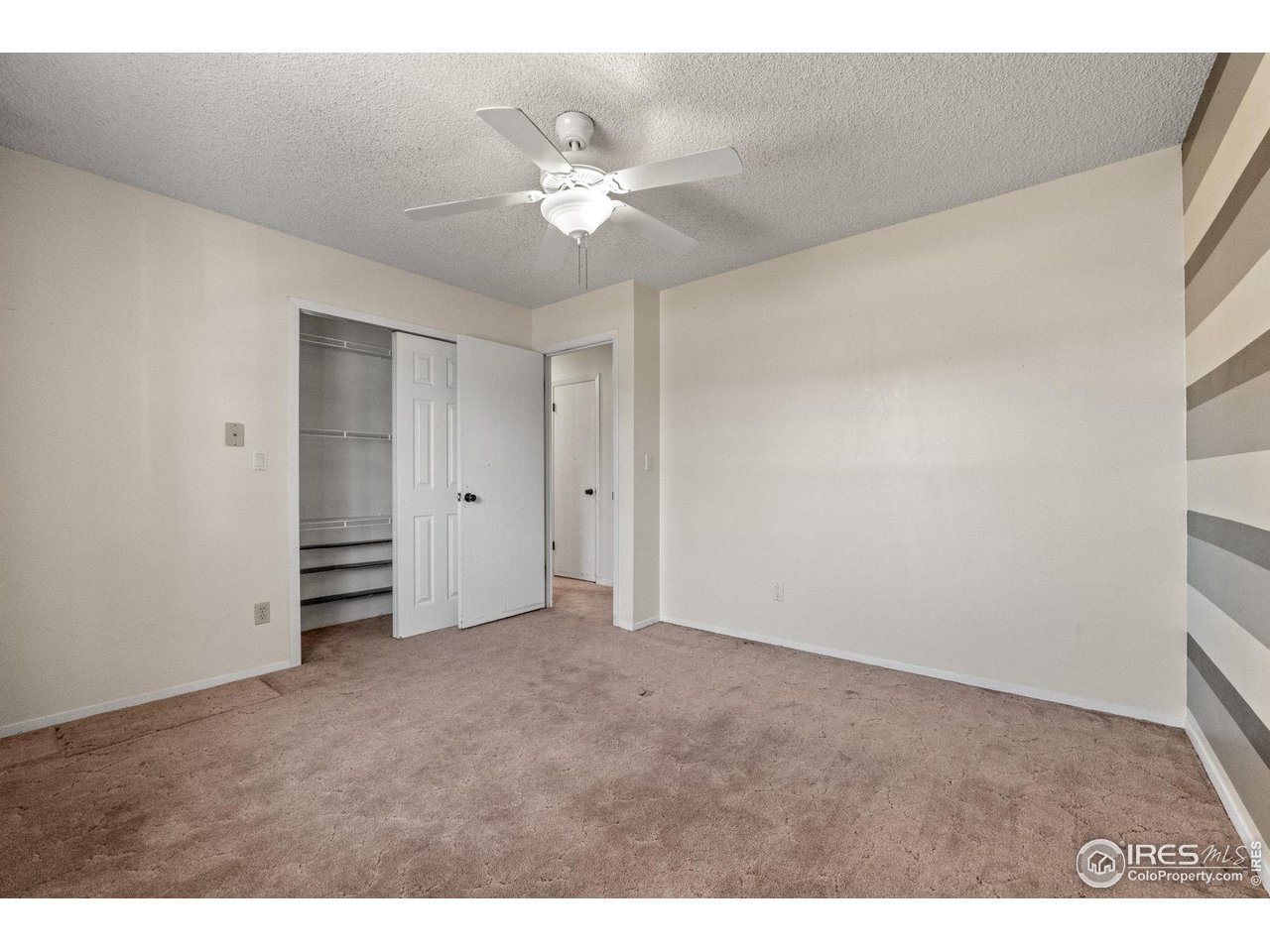 310 Apache Street Fort Morgan, CO 80701 - Photo 21 of 50 a view of an empty room with a fan