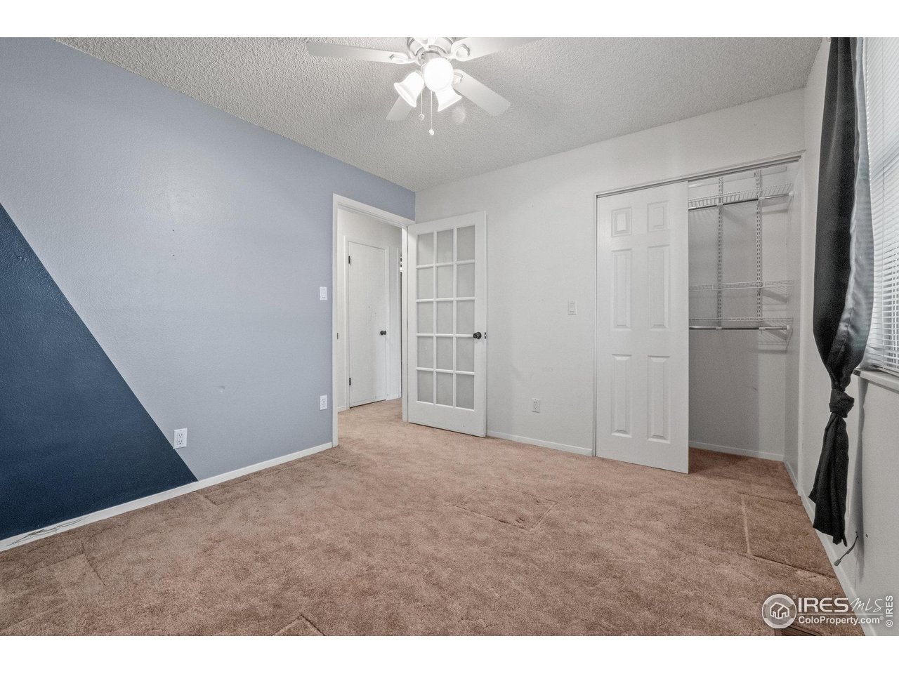 310 Apache Street Fort Morgan, CO 80701 - Photo 23 of 50 a view of empty room with a ceiling fan and window