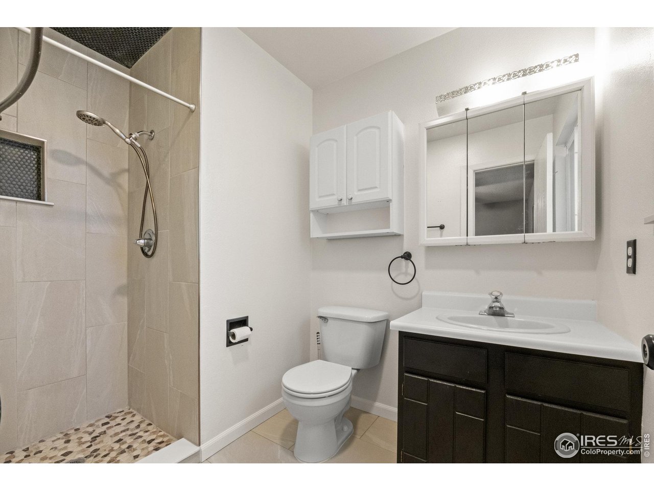 310 Apache Street Fort Morgan, CO 80701 - Photo 26 of 50 a bathroom with a sink a toilet and a mirror