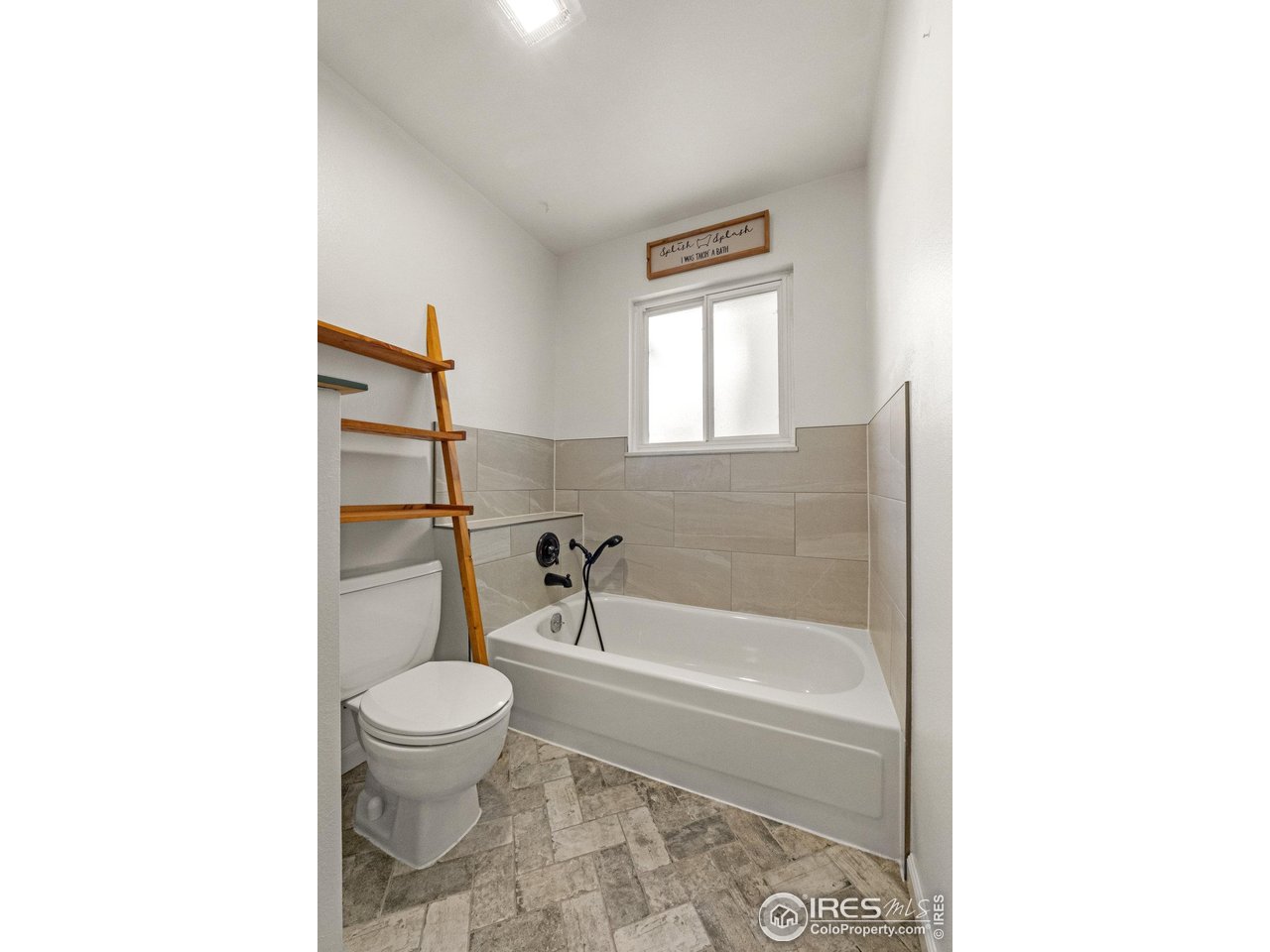 310 Apache Street Fort Morgan, CO 80701 - Photo 28 of 50 a bathroom with a toilet and a bathtub