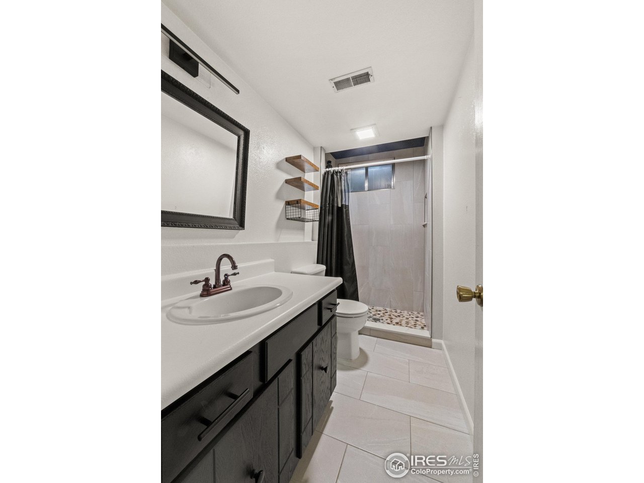 310 Apache Street Fort Morgan, CO 80701 - Photo 39 of 50 a bathroom with a sink and a mirror