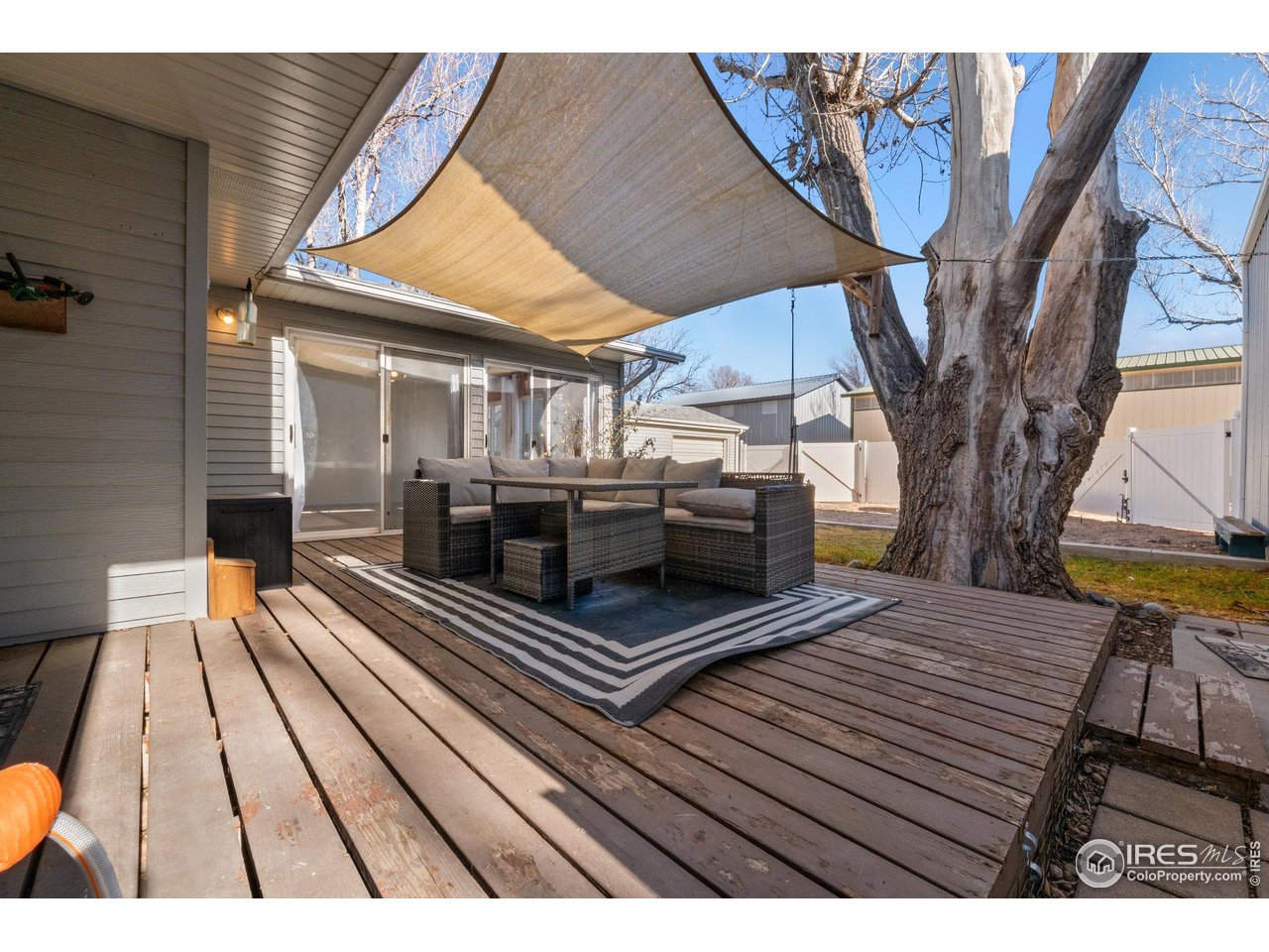 310 Apache Street Fort Morgan, CO 80701 - Photo 41 of 50 a view of deck with wooden floor and seating space