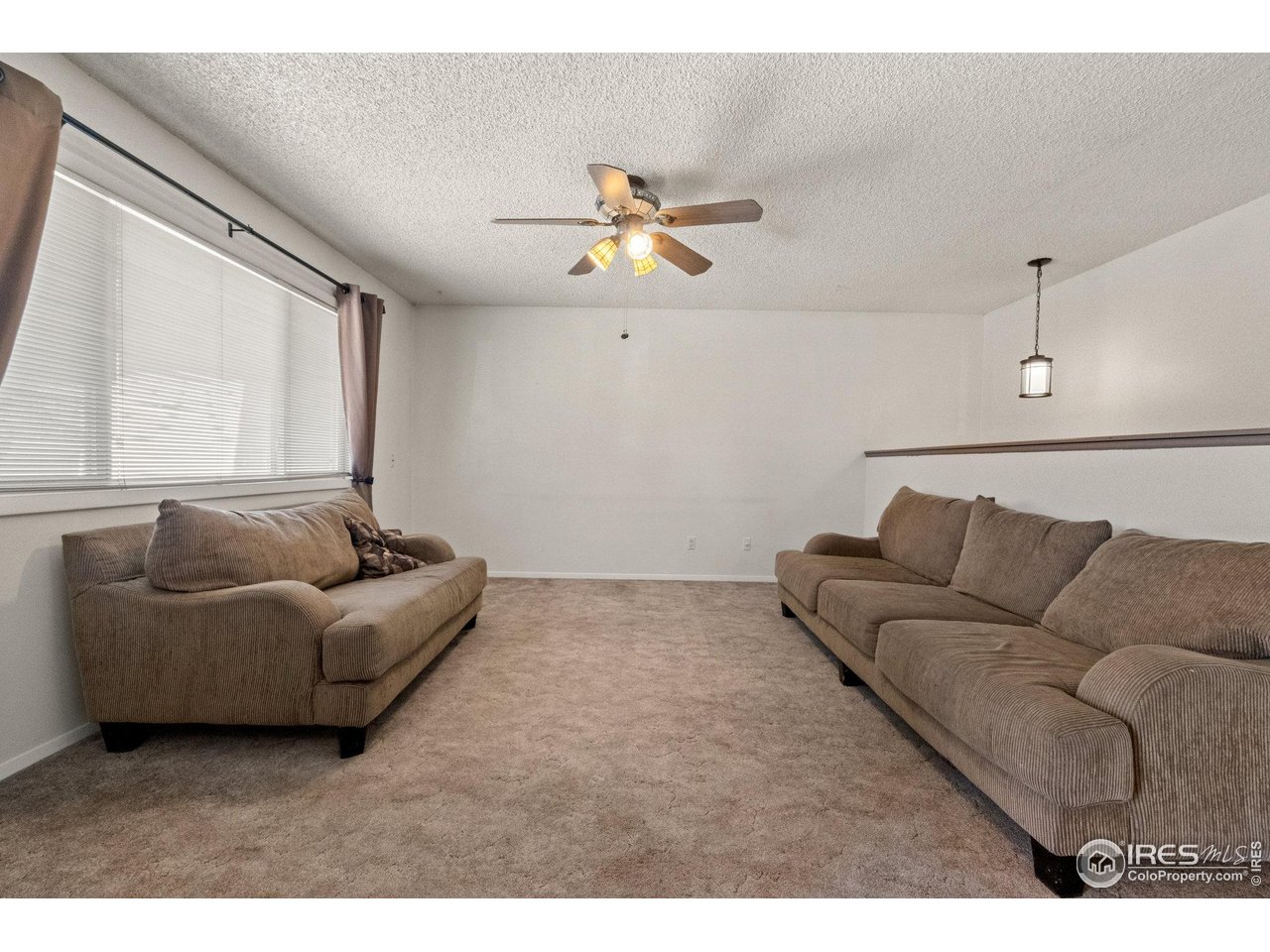 310 Apache Street Fort Morgan, CO 80701 - Photo 5 of 50 a living room with furniture and a large window