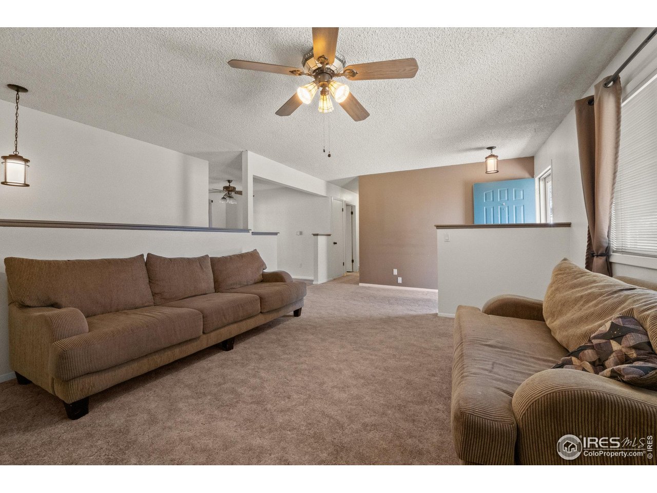 310 Apache Street Fort Morgan, CO 80701 - Photo 6 of 50 a living room with furniture and a ceiling fan