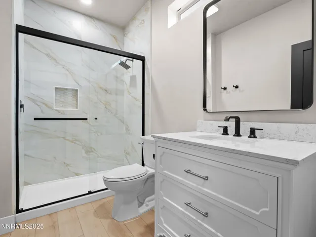 a bathroom with a sink a toilet and a mirror