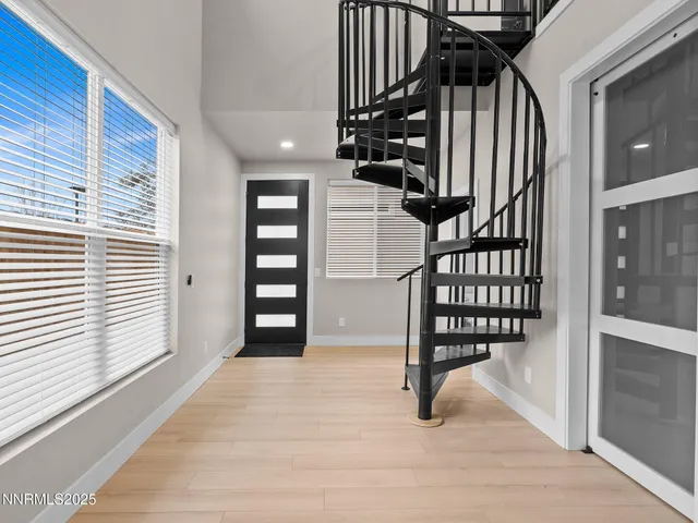 a view of entryway and hall with wooden floor