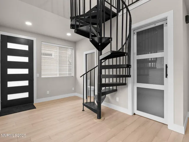 a view of entryway with wooden floor and stairs